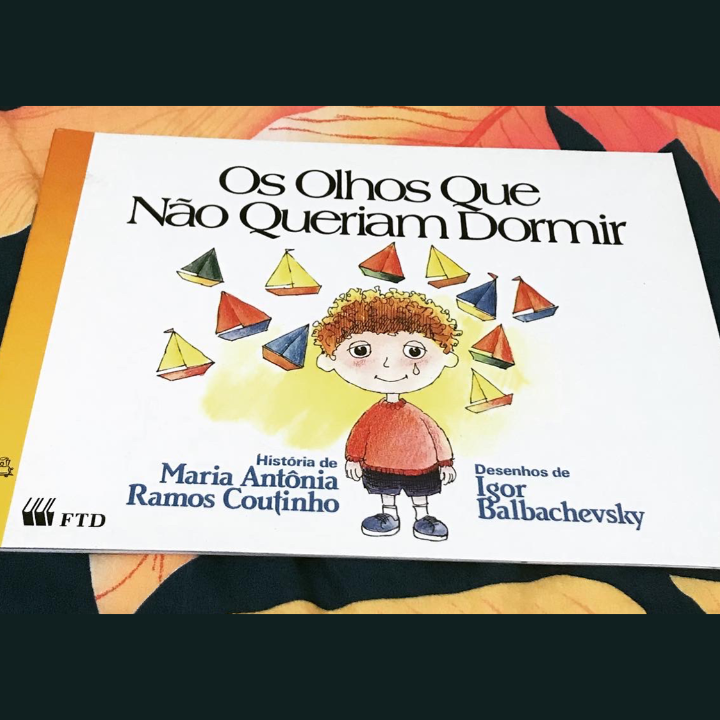 Cover of the original book, with a red-haired child and boats above in a white background